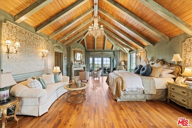 bedroom with a chandelier, beam ceiling, light hardwood / wood-style floors, and high vaulted ceiling