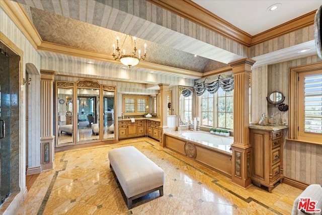 bathroom featuring ornamental molding, ornate columns, and a healthy amount of sunlight