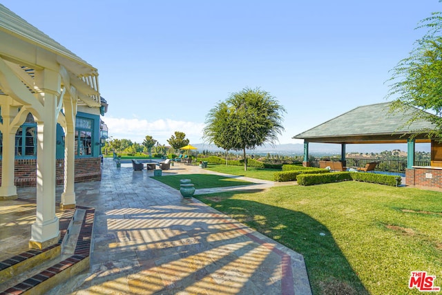 view of community with a patio area, a gazebo, and a yard