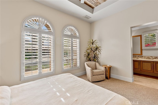 carpeted bedroom featuring ensuite bathroom