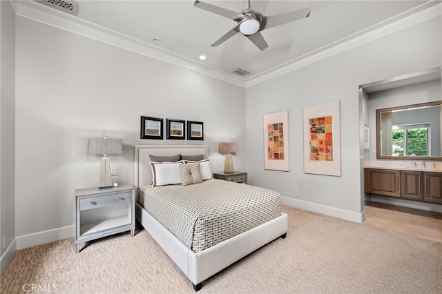 bedroom with ensuite bath, ornamental molding, light colored carpet, and ceiling fan