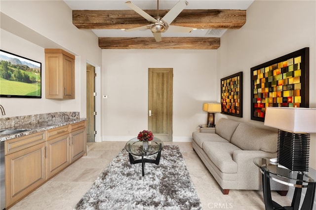 living room with ceiling fan, sink, and beam ceiling