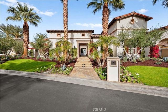 mediterranean / spanish house with a front yard