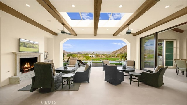 view of patio / terrace with an outdoor living space with a fireplace and a mountain view