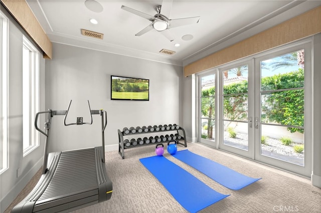 workout area with carpet floors, a healthy amount of sunlight, ceiling fan, and french doors