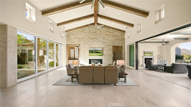 sunroom / solarium featuring a stone fireplace and vaulted ceiling with beams