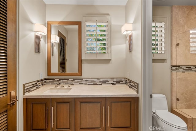 bathroom featuring vanity, decorative backsplash, plenty of natural light, and toilet