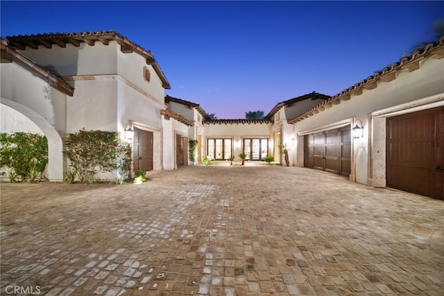 property exterior at dusk with a garage