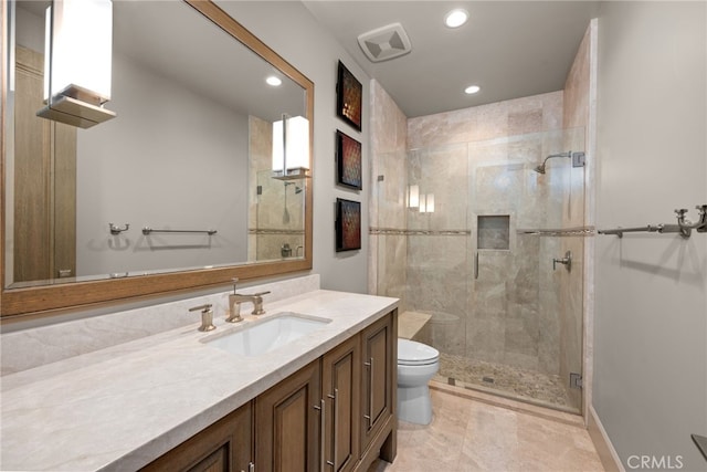 bathroom featuring an enclosed shower, vanity, and toilet