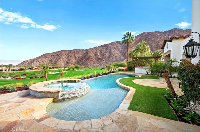 view of pool featuring a mountain view, a patio area, and an in ground hot tub