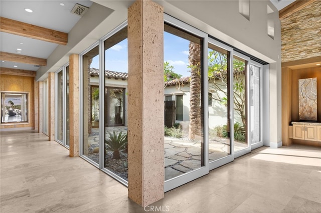 doorway with beamed ceiling