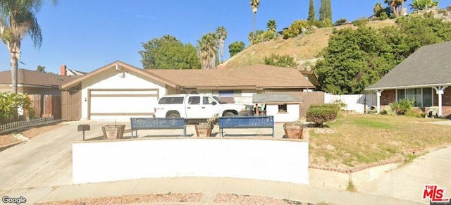 view of front of property with a front yard and a garage