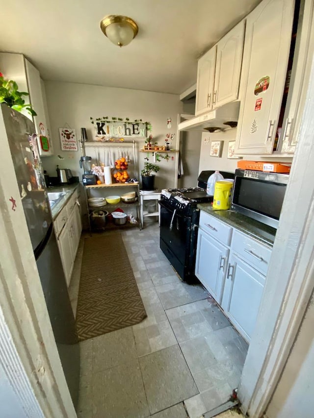 kitchen with white cabinetry and black gas stove