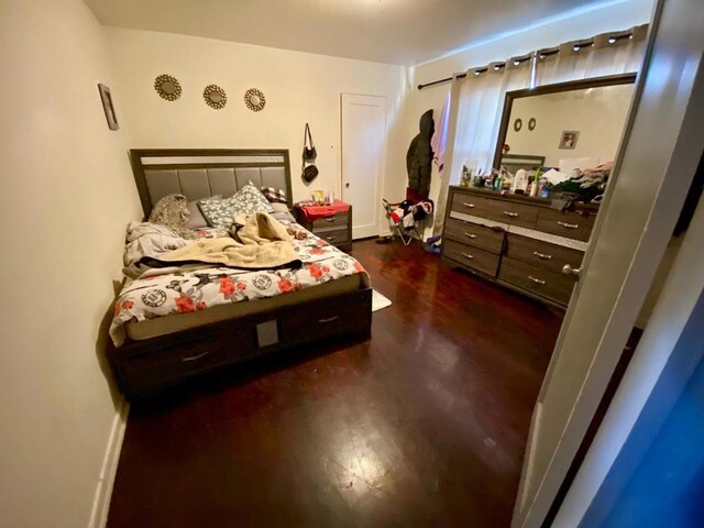 bedroom featuring dark hardwood / wood-style flooring