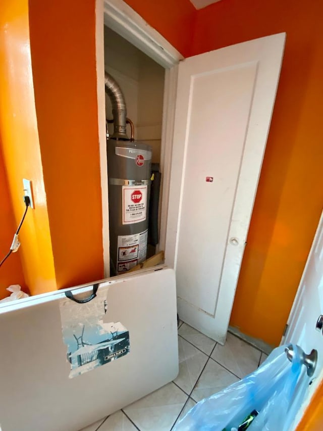 utility room featuring water heater