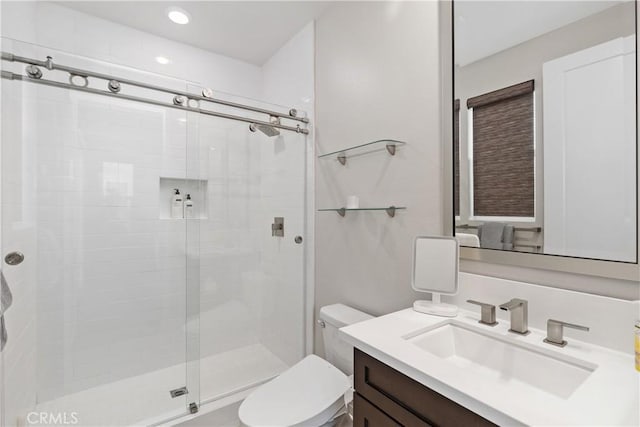 full bathroom featuring recessed lighting, toilet, a stall shower, and vanity