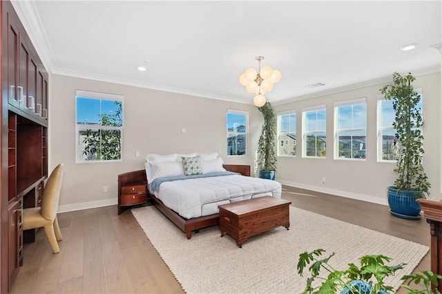 bedroom with ornamental molding, wood-type flooring, and an inviting chandelier