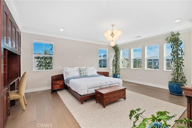 bedroom featuring multiple windows, wood finished floors, baseboards, and ornamental molding