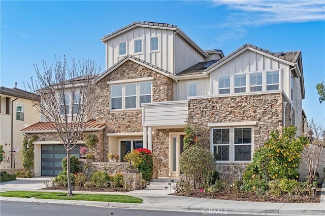 craftsman house featuring stone siding, board and batten siding, and concrete driveway