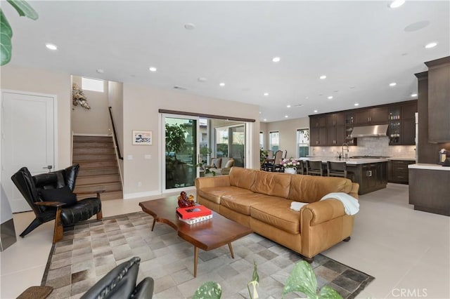 living room with light tile patterned flooring and sink