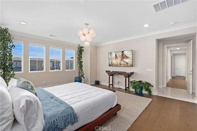 bedroom featuring wood finished floors, baseboards, visible vents, recessed lighting, and ornamental molding