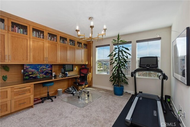 carpeted home office with built in desk