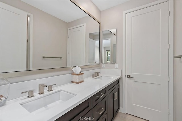 bathroom featuring a sink and double vanity