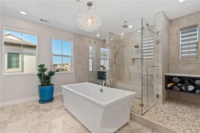 bathroom with visible vents, recessed lighting, a shower stall, baseboards, and a soaking tub