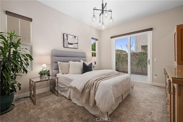 bedroom featuring a chandelier, baseboards, light carpet, and access to exterior