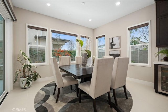 dining space featuring recessed lighting, a healthy amount of sunlight, and baseboards