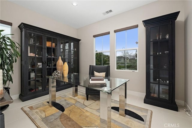 office area with light tile patterned floors, visible vents, and baseboards