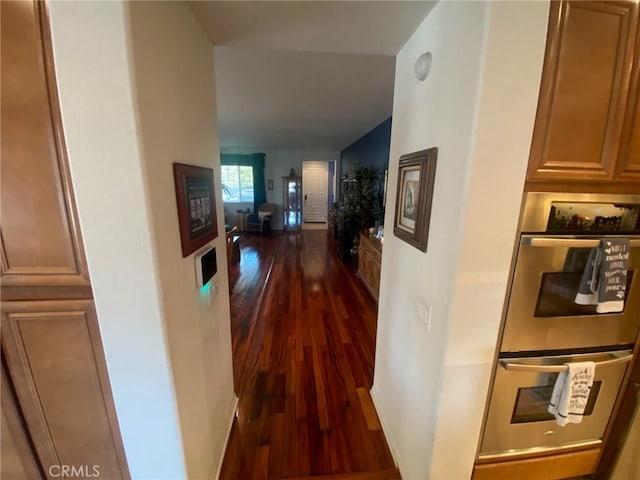 corridor featuring dark hardwood / wood-style floors