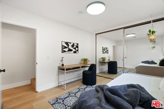 bedroom featuring a closet and light hardwood / wood-style flooring