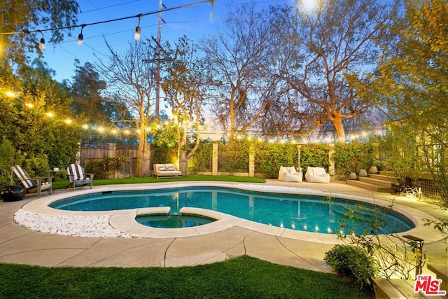 view of swimming pool with a patio area and an in ground hot tub