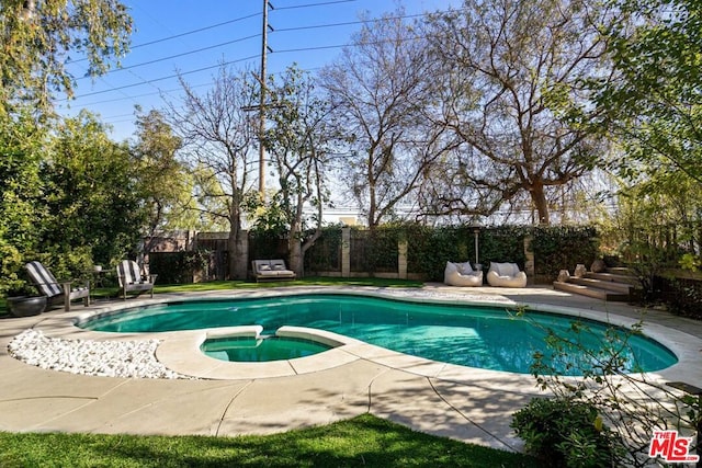 view of swimming pool with an in ground hot tub and a patio