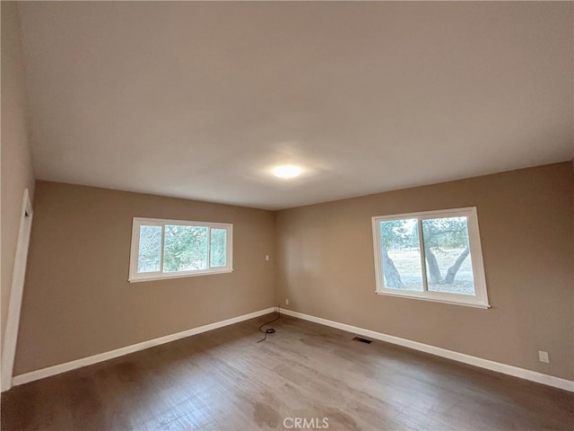 unfurnished room with wood-type flooring