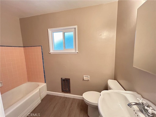 bathroom featuring sink, hardwood / wood-style flooring, and toilet