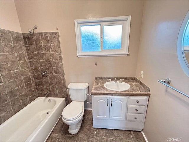 full bathroom with vanity, tiled shower / bath combo, and toilet