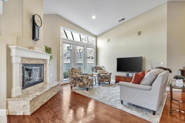 living room with high vaulted ceiling and dark hardwood / wood-style floors