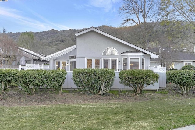 view of home's exterior featuring a mountain view and a yard