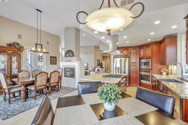 dining room featuring sink and a towering ceiling