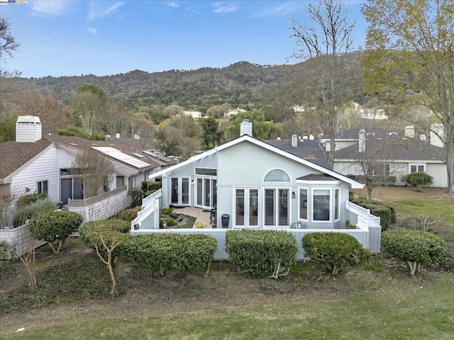 rear view of property featuring a mountain view