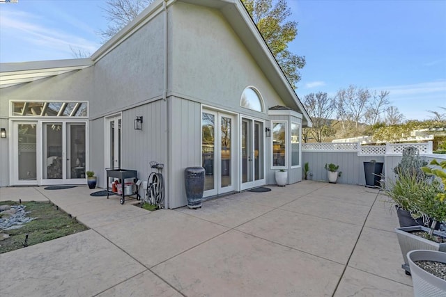 rear view of property featuring french doors and a patio area