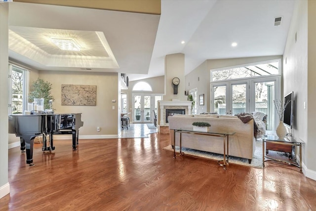 living room featuring hardwood / wood-style flooring, a wealth of natural light, and french doors