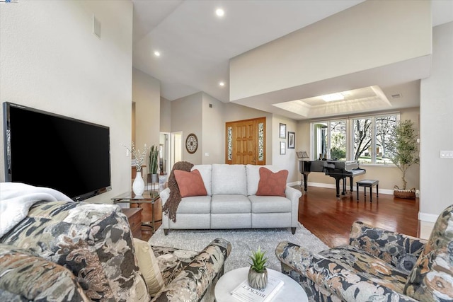 living room featuring hardwood / wood-style floors and a tray ceiling