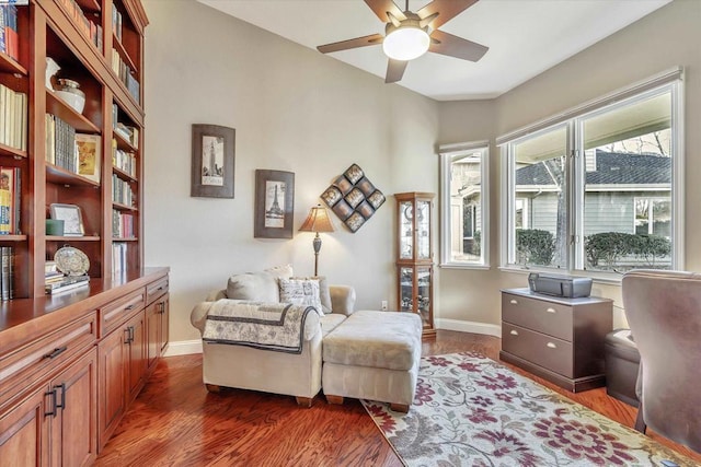 sitting room featuring ceiling fan and dark hardwood / wood-style floors