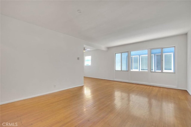 spare room featuring ceiling fan and light hardwood / wood-style flooring