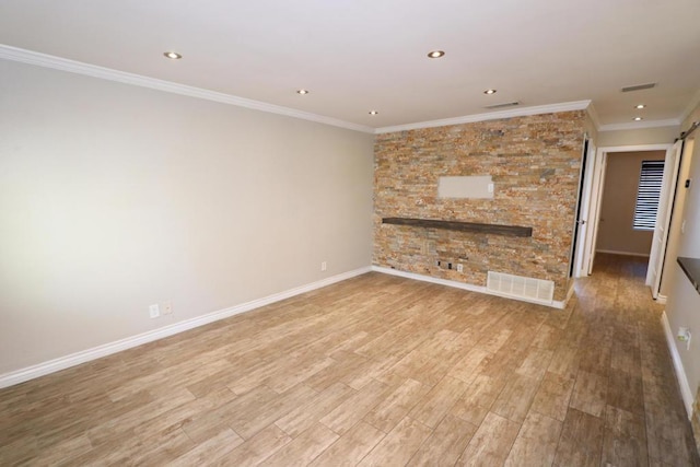 unfurnished living room featuring crown molding and light hardwood / wood-style floors