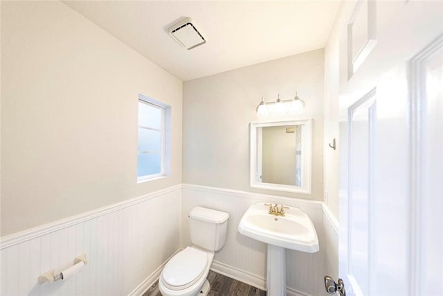 bathroom featuring wood-type flooring and toilet