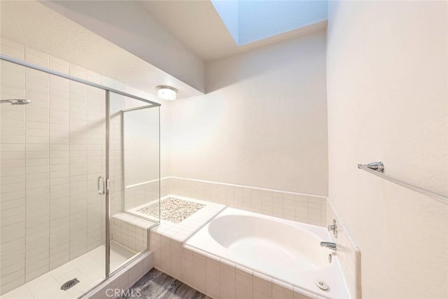 bathroom with a shower with shower door and wood-type flooring